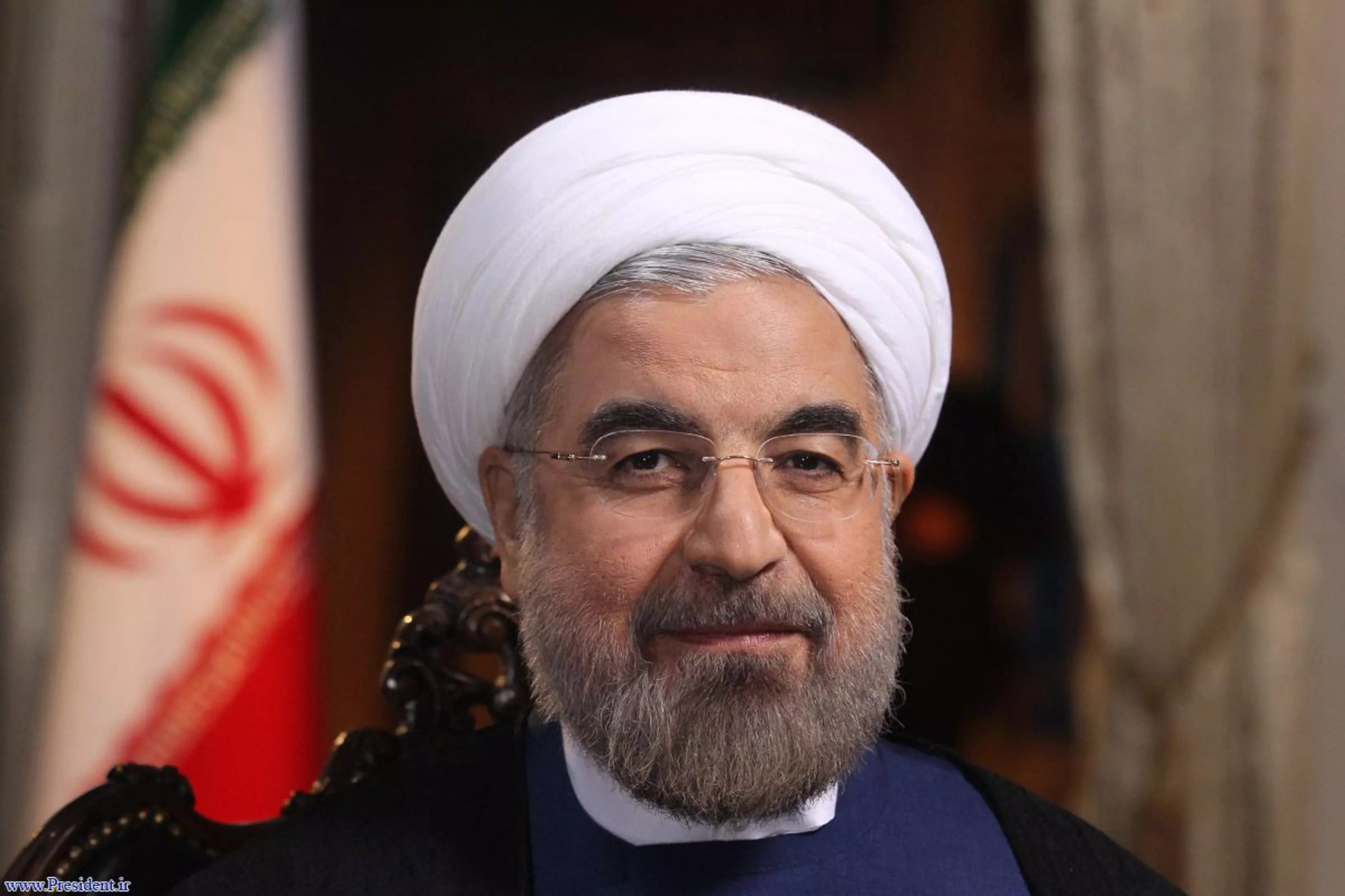 מחייך ללפיד ממרומי המקום ה-18. נשיא איראן רוחאני
