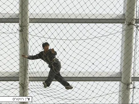 פועל בשדה ההתעופה הבינלאומי החדש של ביג'ינג מתכונן לקראת ניקוי  הגג