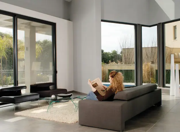 הסלון שמוצף אור יום טבעי הודות לויטרינות גדולות. ממנו ניתן להישיר מבט לעבר הבריכה שנמצאת מימין