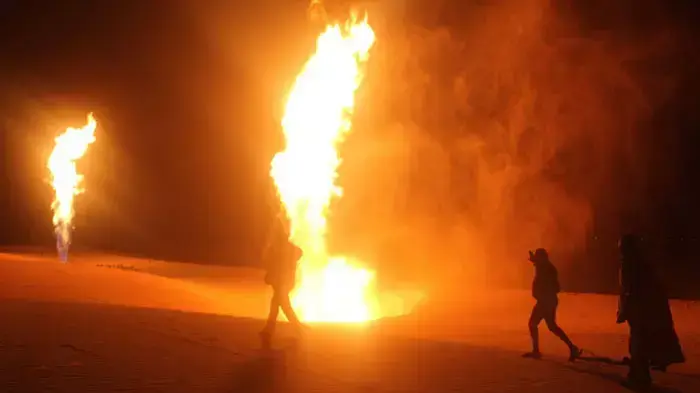תושבים בחצי האי סיני מביטים בלהבות העולות מהצינור המוביל גז לישראל ולירדן, אחרי שאלמונים חיבלו בו. אל-עריש, נובמבר, 2011