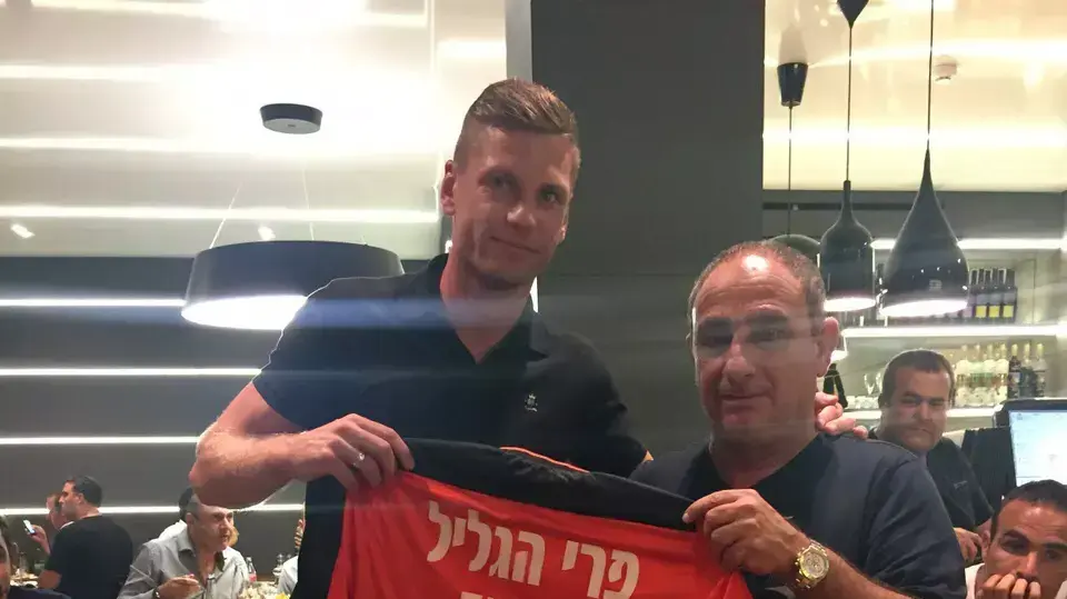 קסטוטיס איבשקביצ'יוס בני יהודה מקבל חולצת פרידה מהמנכ"ל משה דמאיו