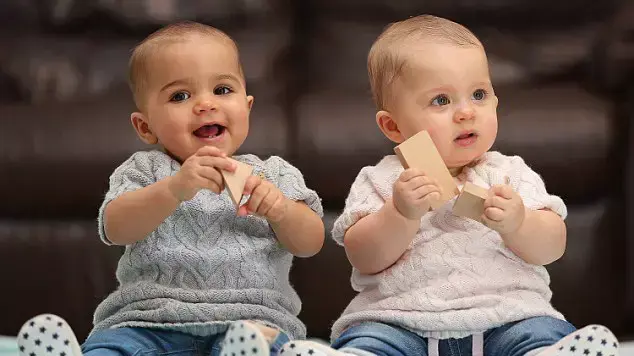 תאומות שאחת כהת עור עם עיניים חומות גדולות והשנייה בהירה עם שיער בלונדיני ועיניים כחולות