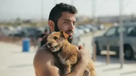 גבר עם זקן מחזיק כלב