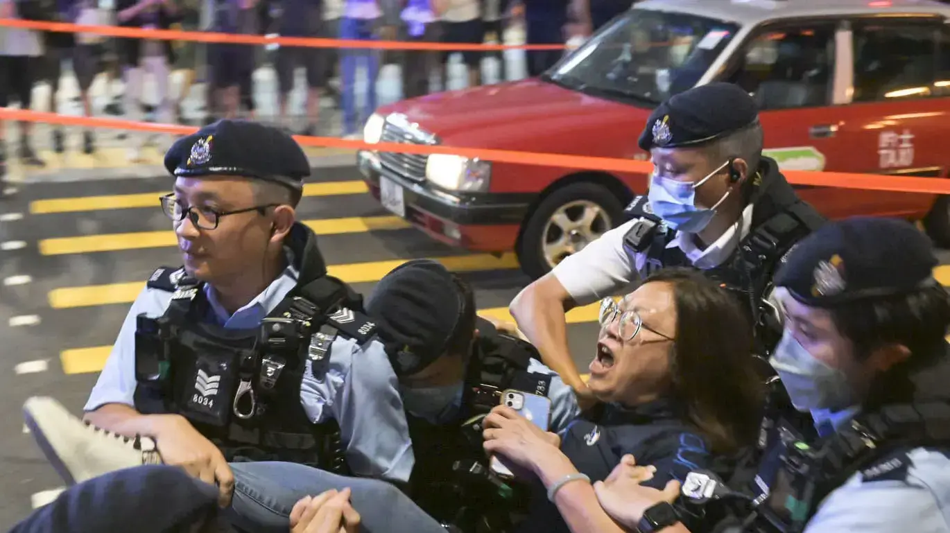 A woman is taken away by authorities in Causeway Bay district in Hong Kong on June 4, 2023, for mourning the victims of China's 1989 Tiananmen Square crackdown on the 34th anniversary of the incident. (Kyodo) ==Kyodo NO USE JAPAN