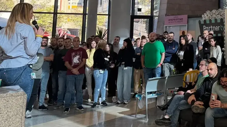 עובדי פרטנר מתכנסים בכניסה למטה החברה בראש העין