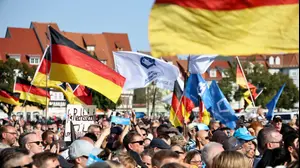 People gather at an election campaign rally of Alternative for Germany (AfD) party ahead of the Thuringia state elections, in Erfurt, Germany August 31, 2024. REUTERS/Karina Hessland