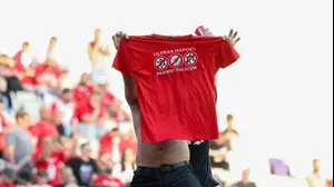 אוהד הפועל תל אביב עם חולצת המחאה ביציע