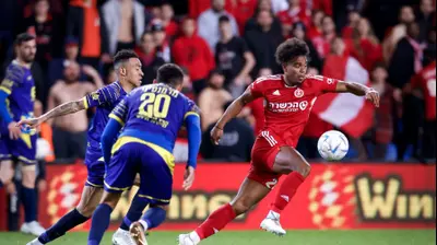 גודפריד רומראטו שחקן הפועל תל אביב לפני אניסה שחקן מכבי בני ריינה. מאור אלקסלסי