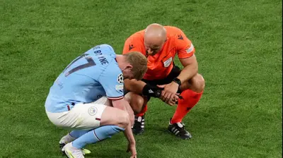 השופט הפולני שימון מרצ'יניאק עם קווין דה בראונה שחקן מנצ'סטר סיטי, גמר ליגת האלופות 2023. רויטרס