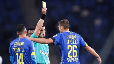 שניר לוי שולף כרטיס צהוב לעבר נמניה ליוביסבלייביץ' שחקן מכבי בני ריינה. מאור אלקסלסי