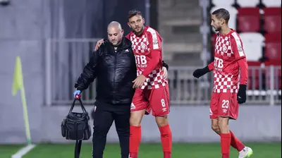 עילאי טרוסט שחקן הפועל חדרה הפצוע, לצדו תמיר עדי. מאור אלקסלסי