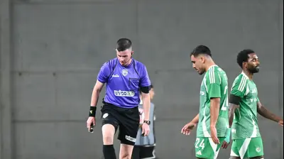 איתן אזולאי שחקן מכבי חיפה לצד השופט רפאל גבע. ברני ארדוב