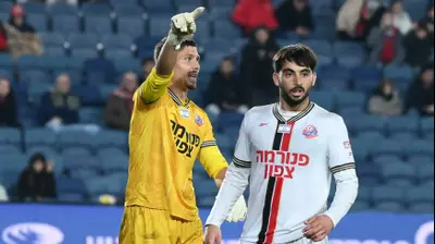 יונתן פרבר שחקן הפועל חיפה עם השוער בנג'מין מצ'יני. ברני ארדוב