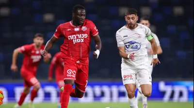 מארון גנטוס שחקן בני סכנין מול רז'יס אנדו שחקן הפועל חיפה. מאור אלקסלסי