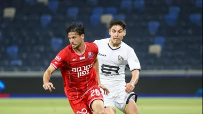 לירן רוטמן שחקן הפועל חיפה לפני אנטוניו ספר שחקן מכבי בני ריינה. קובי אליהו